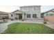 The serene backyard features a lush lawn, stone pathway, BBQ kitchen, and expansive brick patio for outdoor activities at 2211 W Desert Ln, Phoenix, AZ 85041