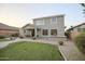 Large backyard features a well-manicured lawn, mature landscaping, brick patio, and covered seating area at 2211 W Desert Ln, Phoenix, AZ 85041