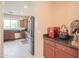 View of the kitchen from the bar area featuring stainless steel appliances at 2211 W Desert Ln, Phoenix, AZ 85041