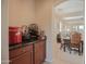 Entertaining bar with dark cabinets, granite counter, and elegant wine storage at 2211 W Desert Ln, Phoenix, AZ 85041
