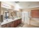 Bathroom with dual sinks, a bathtub, and a shower with glass door at 2211 W Desert Ln, Phoenix, AZ 85041