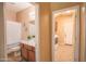A bathroom featuring a sink and a view to the laundry area at 2211 W Desert Ln, Phoenix, AZ 85041