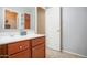Bathroom featuring a vanity with a white countertop and cherry wood cabinets at 2211 W Desert Ln, Phoenix, AZ 85041