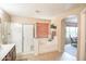 Bathroom featuring a separate shower and soaking tub, vanity, and an arched doorway into another room at 2211 W Desert Ln, Phoenix, AZ 85041
