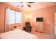 A cozy, carpeted bedroom with a black leather chair and window at 2211 W Desert Ln, Phoenix, AZ 85041