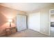 A simple bedroom with carpet, closet, and minimal furnishings at 2211 W Desert Ln, Phoenix, AZ 85041