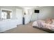 A bright bedroom with a dresser, fan, mirror, and comfortable bed at 2211 W Desert Ln, Phoenix, AZ 85041