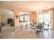 Dining area with glass table top and decorative chairs adjacent to the living room at 2211 W Desert Ln, Phoenix, AZ 85041