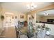 Eat in kitchen with glass table top, chandelier and decorative chairs at 2211 W Desert Ln, Phoenix, AZ 85041