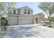 Beautiful two-story home boasts a three-car garage and a meticulously landscaped front yard at 2211 W Desert Ln, Phoenix, AZ 85041