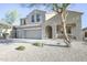 Beautiful home features desert landscaping, a two-car garage, and a cozy covered porch at 2211 W Desert Ln, Phoenix, AZ 85041
