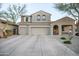 Charming two-story home featuring desert landscaping, a two-car garage, and a covered porch at 2211 W Desert Ln, Phoenix, AZ 85041