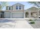 Charming two-story home featuring a three-car garage and well-maintained front yard at 2211 W Desert Ln, Phoenix, AZ 85041
