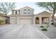 Home features a three-car garage, low-maintenance desert landscaping, covered porch, and tile roof at 2211 W Desert Ln, Phoenix, AZ 85041
