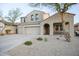 Beautiful two-story home with a three-car garage and a desert landscaped front yard, enhancing its curb appeal at 2211 W Desert Ln, Phoenix, AZ 85041