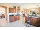Open kitchen with lots of counter space, dark cabinets and island with seating at 2211 W Desert Ln, Phoenix, AZ 85041