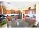 Updated kitchen features stainless appliances, granite counters, island, and ample cabinets at 2211 W Desert Ln, Phoenix, AZ 85041