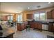 Spacious open kitchen features dark cabinets, granite counters, and a cozy breakfast nook at 2211 W Desert Ln, Phoenix, AZ 85041