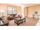 Comfortable living room with a leather sofa, carpet floors and natural light at 2211 W Desert Ln, Phoenix, AZ 85041