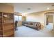 Bright living room with neutral tones, plush carpeting, and a cozy seating area at 2211 W Desert Ln, Phoenix, AZ 85041