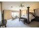 Spacious main bedroom featuring a luxurious four-poster bed, sitting area, and ample natural light at 2211 W Desert Ln, Phoenix, AZ 85041