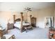 Large main bedroom with a four-poster bed, elegant furnishings, and a serene atmosphere at 2211 W Desert Ln, Phoenix, AZ 85041