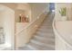 Carpeted staircase with white railing and decorative niches adding architectural interest at 2211 W Desert Ln, Phoenix, AZ 85041