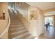 Carpeted staircase with a white handrail and neutral walls at 2211 W Desert Ln, Phoenix, AZ 85041