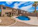 This backyard has a pool, large patio, palm tree, and a lush lawn at 22123 E Vía Del Palo --, Queen Creek, AZ 85142