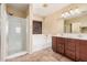 Bathroom featuring a glass shower, separate bathtub, dual sinks, and tile flooring at 22123 E Vía Del Palo --, Queen Creek, AZ 85142