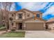 Charming two-story home with a two-car garage, well-kept lawn, and beautiful desert landscaping at 22123 E Vía Del Palo --, Queen Creek, AZ 85142