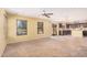 Bright and airy living room featuring carpeted floors, large windows, and an open floor plan at 22123 E Vía Del Palo --, Queen Creek, AZ 85142