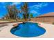 This pool has blue water, a rock feature, and views of the golf course beyond the fence at 22123 E Vía Del Palo --, Queen Creek, AZ 85142