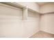 Walk-in closet with carpet flooring and ample storage space with built-in shelves at 22123 E Vía Del Palo --, Queen Creek, AZ 85142