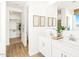 Bathroom features a double sink vanity, framed art, and a walk-in closet at 22490 W Tonopah Dr, Surprise, AZ 85387