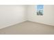 This bedroom features neutral carpeting and a large window at 22490 W Tonopah Dr, Surprise, AZ 85387