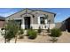 Lovely single-story home featuring desert landscaping and decorative architectural details at 22490 W Tonopah Dr, Surprise, AZ 85387
