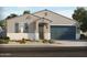 Charming single-Gathering home with a well-manicured front yard and a two-car garage at 22490 W Tonopah Dr, Surprise, AZ 85387