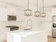 Modern kitchen featuring white cabinets, stainless appliances, and a center island with pendant lighting at 22490 W Tonopah Dr, Surprise, AZ 85387