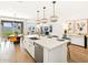 Open-concept kitchen with stainless steel appliances, an island, and pendant lighting at 22490 W Tonopah Dr, Surprise, AZ 85387