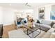 Spacious living room with hard surface floors, a ceiling fan, and an open floor plan at 22490 W Tonopah Dr, Surprise, AZ 85387