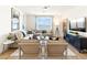 Bright living room featuring stylish furniture, a large window, and contemporary decor at 22490 W Tonopah Dr, Surprise, AZ 85387