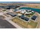 Aerial view of the community playground featuring covered picnic areas, colorful play structures, and splash pad at 22609 E Roundup Way, Queen Creek, AZ 85142