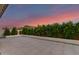 Serene backyard featuring a modern patio with manicured hedges and privacy landscaping at 22609 E Roundup Way, Queen Creek, AZ 85142