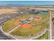 Aerial view of baseball fields, tennis courts and parking in a well designed community at 22609 E Roundup Way, Queen Creek, AZ 85142