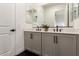 Double vanity in bathroom with dual sinks, quartz countertop, and contemporary fixtures at 22609 E Roundup Way, Queen Creek, AZ 85142