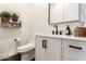 Stylish half-bathroom features a modern vanity, black fixtures, and decorative shelving at 22609 E Roundup Way, Queen Creek, AZ 85142