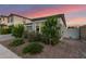 Gray home featuring mature bushes and trees, desert landscaping, and a gray stucco exterior at 22609 E Roundup Way, Queen Creek, AZ 85142