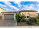 Charming home featuring a gray stucco exterior, a gray garage door, and lovely curb appeal at 22609 E Roundup Way, Queen Creek, AZ 85142