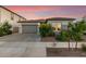 Charming home featuring a gray stucco exterior, a gray garage door, and lovely curb appeal at 22609 E Roundup Way, Queen Creek, AZ 85142